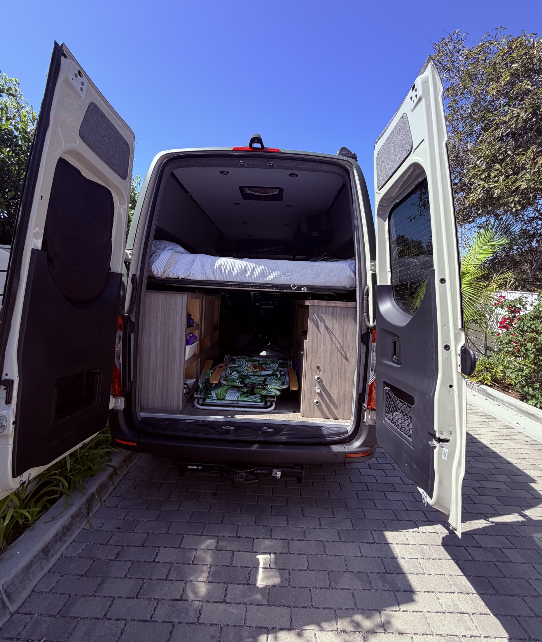 Rear doors open to show the raised bed and large garage storage area